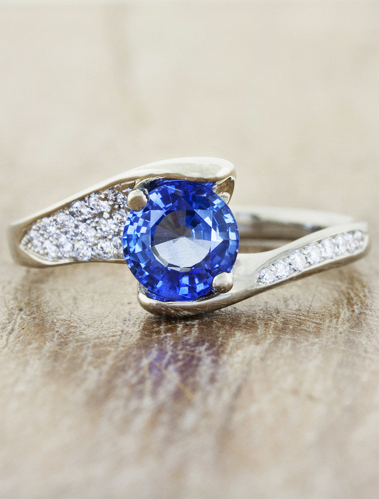 caption:Shown with blue sapphire center in platinum