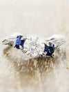 caption:Shown with round diamond & blue sapphire side stones in platinum