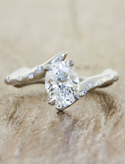unique asymmetrical band oval diamond ring;caption:1.00ct. Oval Diamond Platinum