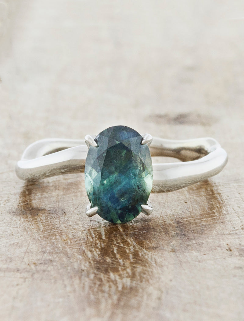 caption:Shown customized with oval sapphire center stone in platinum