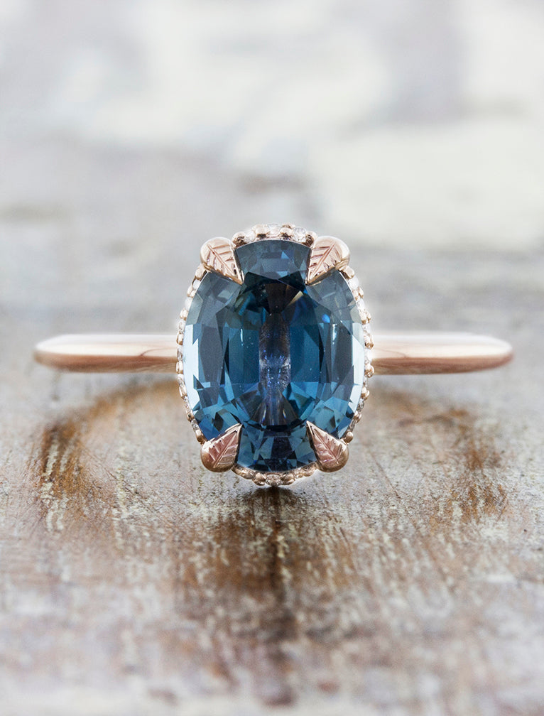 caption:Shown with blue sapphire set against rose gold