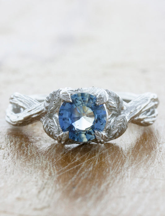 caption:Shown with round blue sapphire in platinum