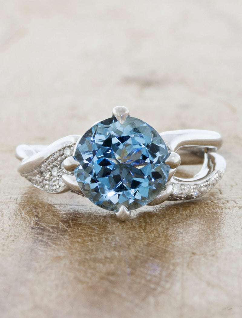 caption:Shown with rough light blue sapphire in platinum