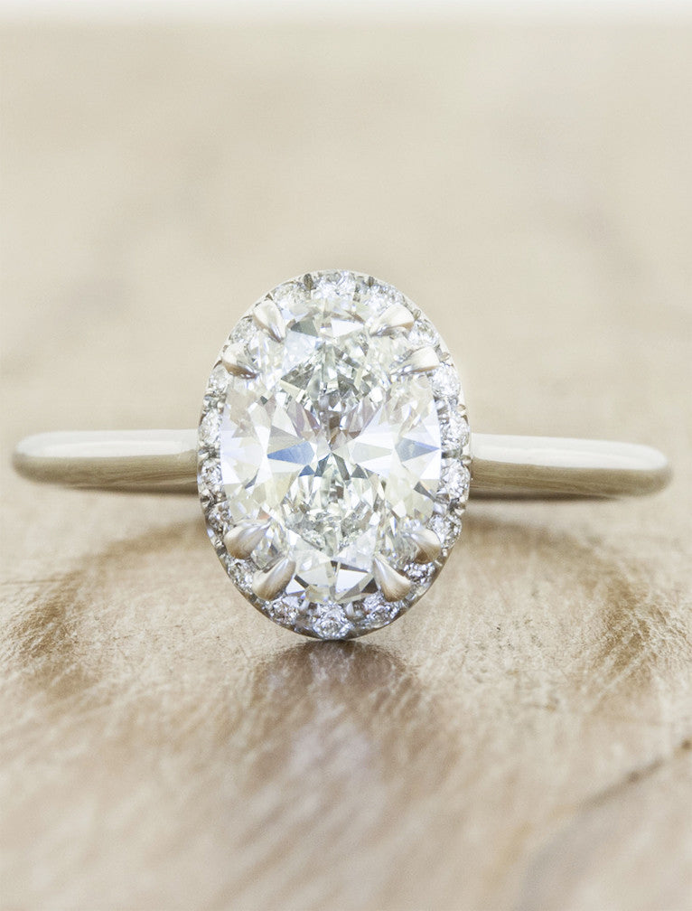 oval diamond subtle halo engagement ring;caption:1.50ct. Oval Diamond Platinum