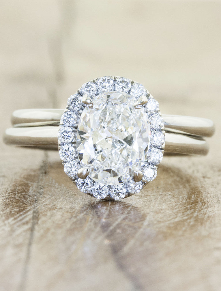 Unique engagement ring halo;caption:1.25ct. Oval Diamond Platinum paired with Lorena wedding band