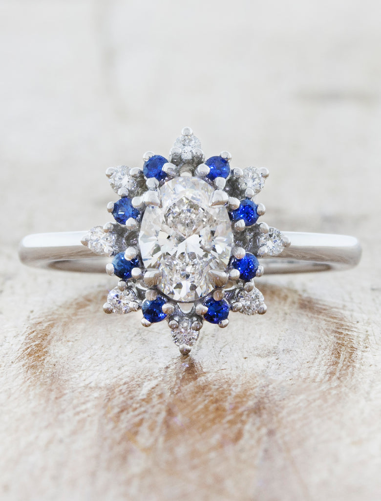oval engagement ring with vintage inspired star halo. caption:Shown with an 0.90ct oval center diamond