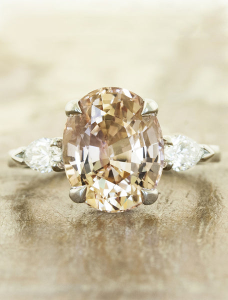 Oval diamond three stone engagement ring, pear side diamonds;caption:4.00ct. Oval Sapphire Platinum