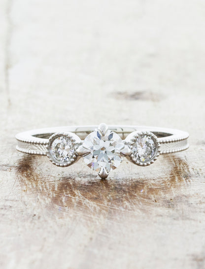 Three Stone Diamond Ring in Platinum. caption:Shown in 0.50ct center diamond option.