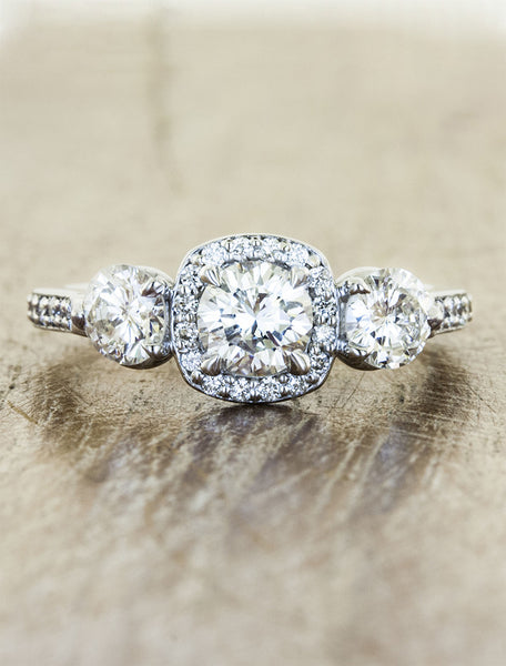 vintage-inspired three stone diamond ring, halo. caption:Shown with 0.45ct center diamond