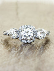 vintage-inspired three stone diamond ring, halo. caption:Shown with 0.45ct center diamond