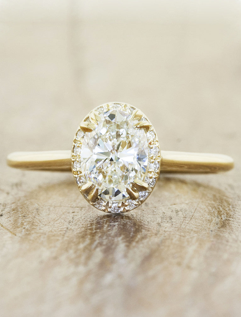 oval diamond engagement ring with subtle halo;caption:1.20ct. Oval Diamond 14k Yellow Gold