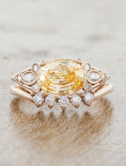caption:Set with peach color sapphire and paired with Antoinette wedding band