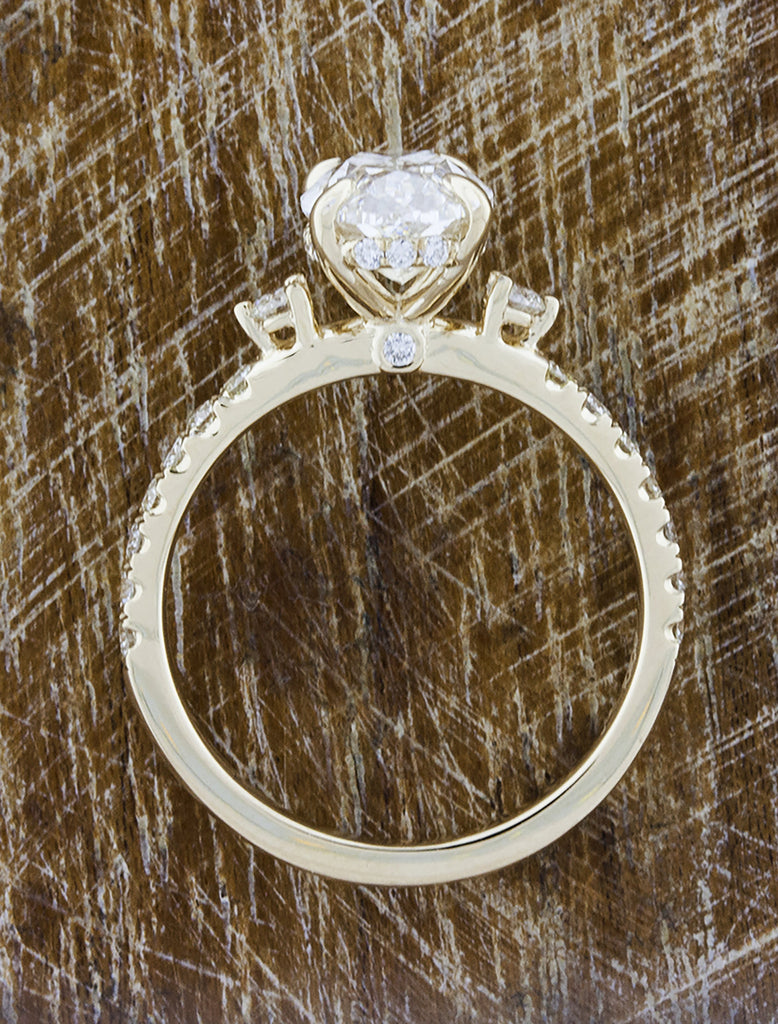 Oval Diamond Flanked by Side Stones in Pave Band caption:Shown in 14k yellow gold