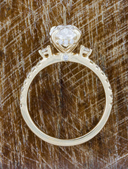 Oval Diamond Flanked by Side Stones in Pave Band