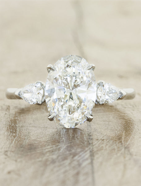 oval diamond three stone engagement ring, pear side diamonds;caption:2.00ct. Oval Diamond Platinum