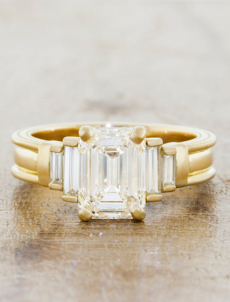 caption:Shown with a 2ct emerald cut center stone in 14k yellow gold