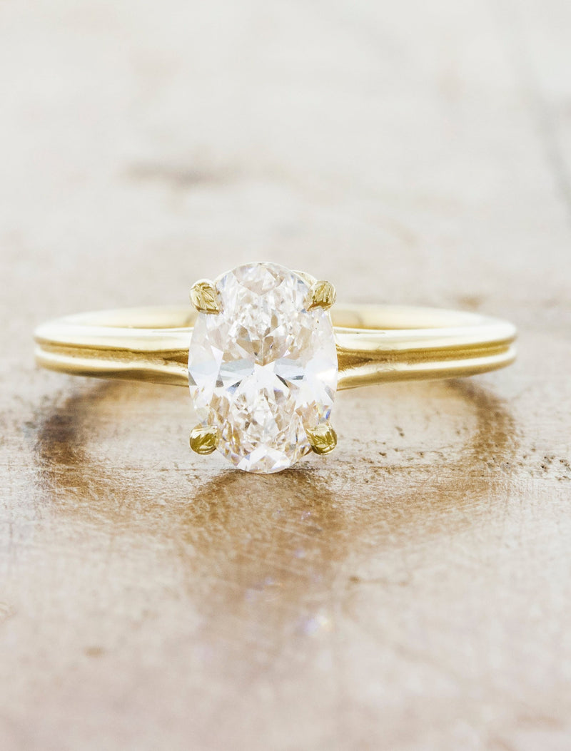 caption:Shown with 1ct oval diamond in 14k yellow gold, customized with leaf prongs