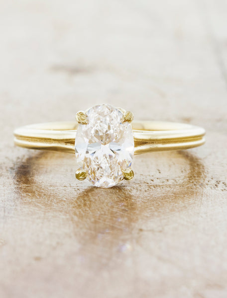 Double band solitaire;caption:1.10ct. Oval Diamond 14k Yellow Gold, customized with leaf detailing on the prongs