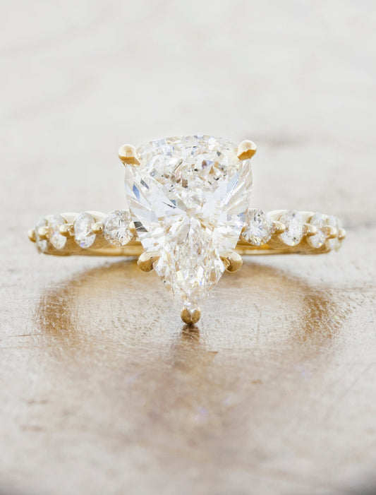 caption:Shown with a 3ct pear cut diamond in 14k yellow gold