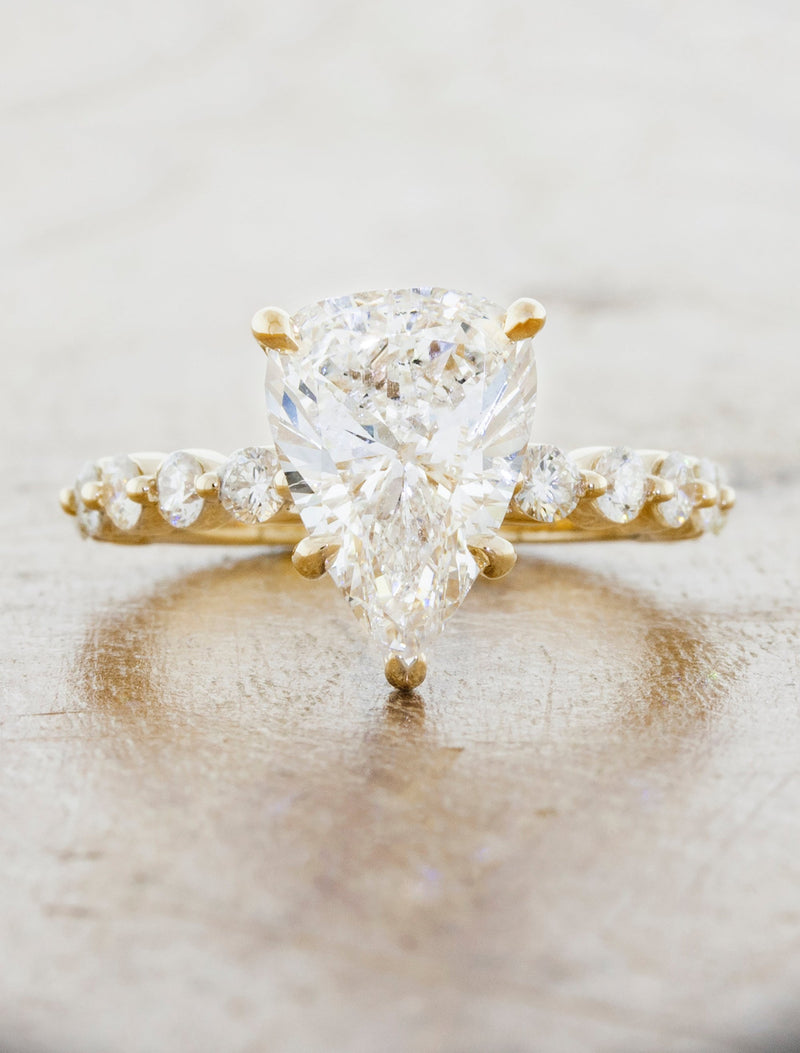 caption:Shown with a 3ct pear cut diamond in 14k yellow gold