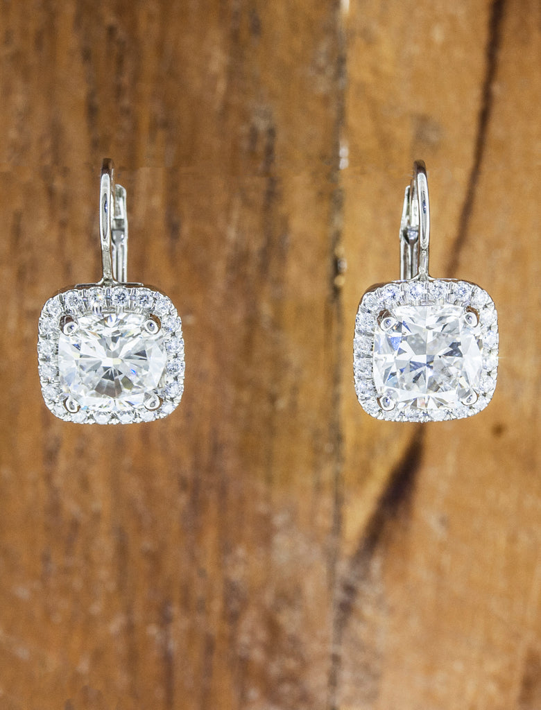 Halo diamond earrings caption: 1.50ct cushion cut diamond in platinum