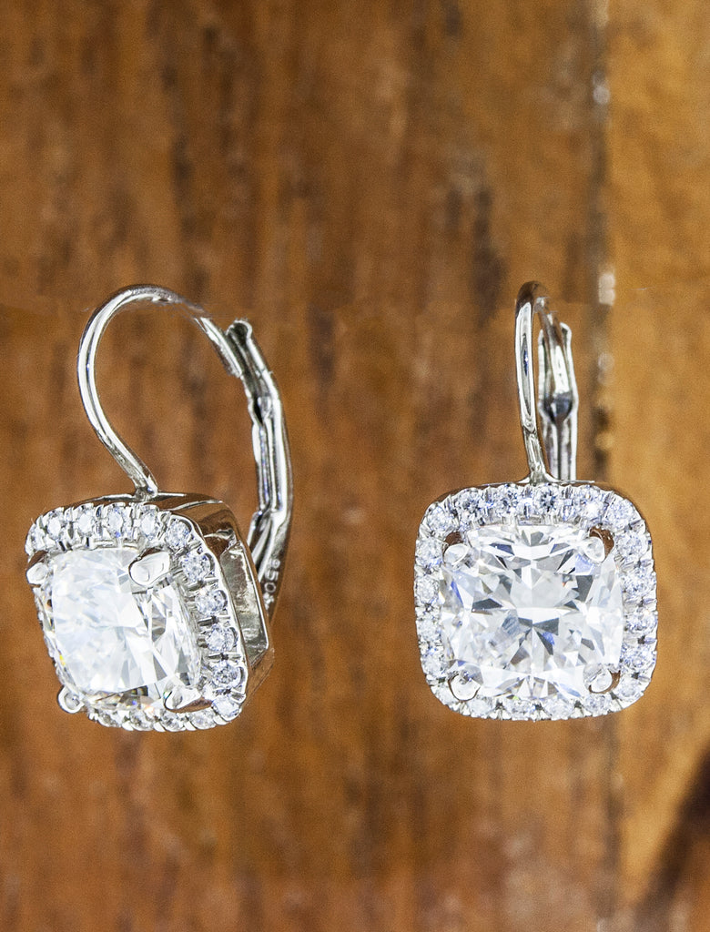 Halo diamond earrings caption: 1.50ct cushion cut diamond in platinum
