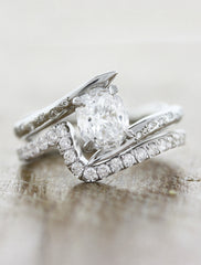 unique asymmetrical band oval diamond ring;caption:0.90ct. Oval Diamond 14k White Gold paired with Ziggy wedding band