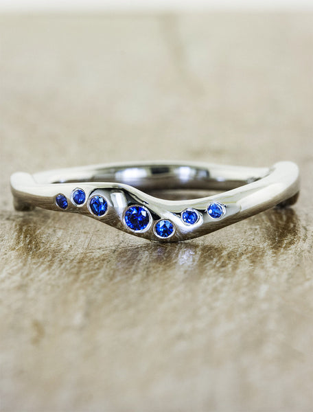 wavy wedding band with sapphires. caption:Customized with sapphires